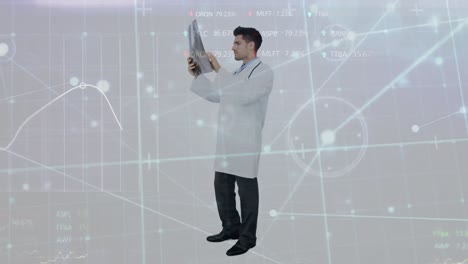 Animation-of-data-processing,-network-of-connections-over-caucasian-male-doctor-examining-x-ray