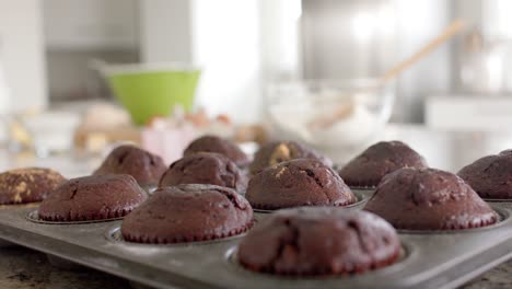 Close-up-of-chocolate-muffins-on-countertop-in-kitchen-slow-motion