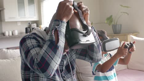African-american-grandfather-and-grandson-using-vr-headset,-playing-video-game,-slow-motion