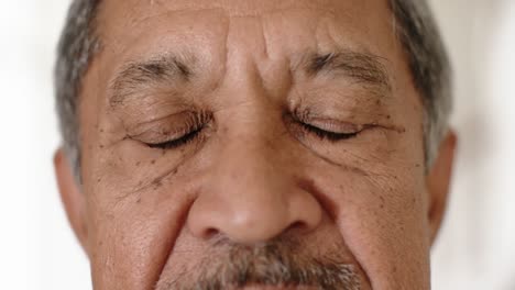 Close-up-portrait-of-eyes-of-biracial-senior-man-at-home,-slow-motion