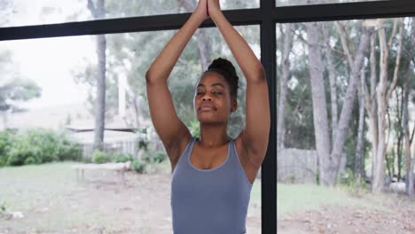 Portrait-of-african-american-woman-meditating-in-yoga-studio,-slow-motion