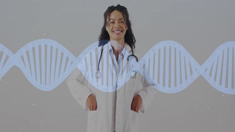 Animation-of-dna-strand-moving-over-smiling-biracial-female-doctor-on-grey-background