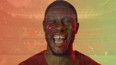 Animation-of-confetti-over-smiling-african-american-footballer-celebrating-and-flag-of-portugal