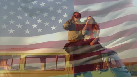 Animation-of-flag-of-america,-diverse-couple-with-blanket-and-drink-sitting-on-van-against-sky