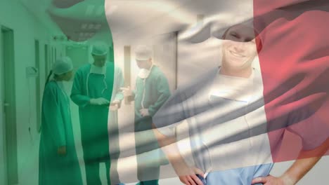 Animation-of-flag-of-italy-waving-over-smiling-caucasian-surgeon-standing-in-corridor-of-hospital