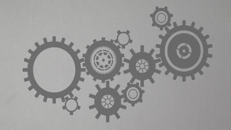 Animation-of-moving-moving-mechanical-gears-against-gray-background