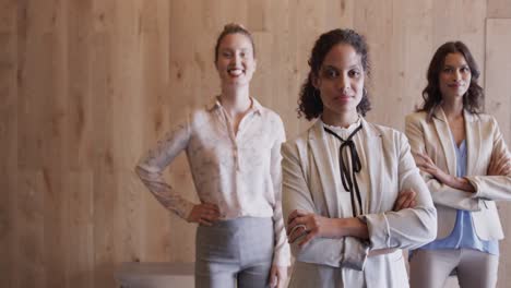 Portrait-of-happy-diverse-female-colleagues-in-office-foyer,-slow-motion