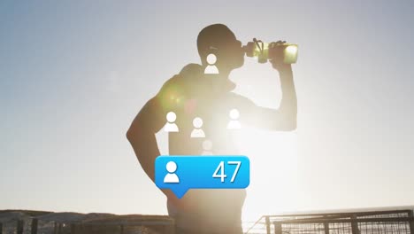 Animation-of-people-icons-with-numbers-over-african-american-male-athlete-drinking-water-against-sky