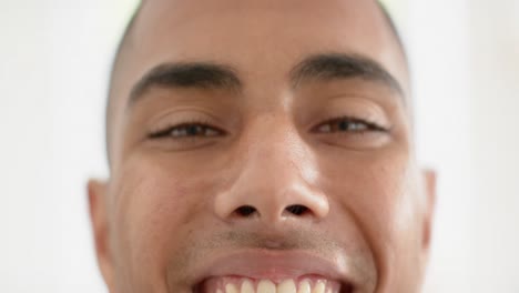 Portrait-of-happy-eyes-of-biracial-man-on-white-background,-slow-motion
