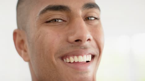 Portrait-of-happy-biracial-man-on-white-background,-slow-motion