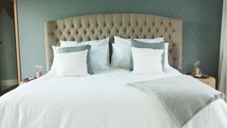 General-view-of-bed-with-white-sheets-in-bedroom,-slow-motion