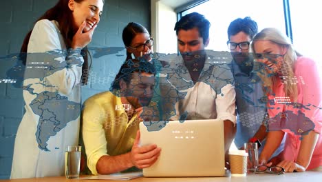 Animation-of-map-and-geometric-shapes-over-diverse-coworkers-discussing-reports-on-laptop-in-office