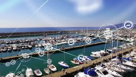 Animation-of-graph-and-globe-connected-icons-over-aerial-view-of-boat-parked-at-marina