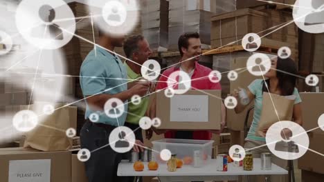 Animation-of-connected-people-icon-over-diverse-coworkers-putting-food-and-drinks-in-box-held-by-man