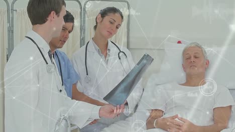 Animation-of-connected-dots-over-caucasian-doctors-discussing-x-ray-reports-and-talking-to-patient