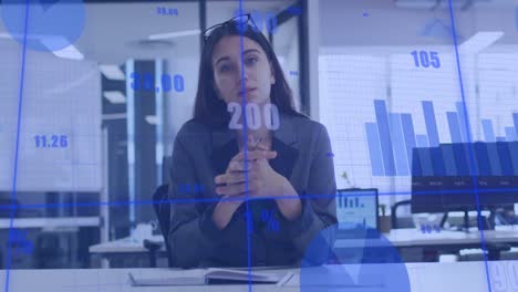 Animation-of-statistical-data-and-graphs,-caucasian-woman-looking-at-camera-and-discussing-in-office