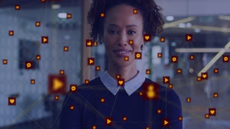 Animation-of-network-of-digital-icons-against-biracial-woman-smiling-at-office