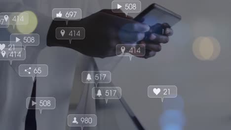 Animation-of-numbers-in-notification-bars,-midsection-of-african-american-doctor-using-cellphone