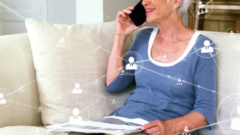 Animation-of-network-of-connections-with-icons-over-caucasian-businesswoman-on-smartphone