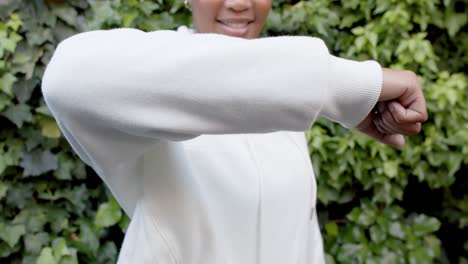 Midsection-of-happy-african-american-woman-in-white-hooded-sweatshirt,-copy-space,-slow-motion