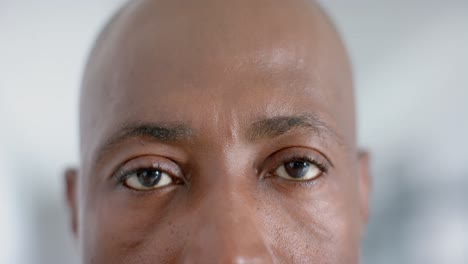 Close-up-of-portrait-of-happy-african-american-male-doctor-smiling,-copy-space,-slow-motion