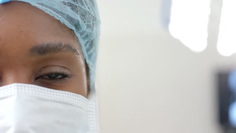 Portrait-of-african-american-female-surgeon-wearing-face-mask,-copy-space,-slow-motion