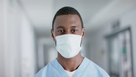Portrait-of-african-american-male-doctor-wearing-face-mask,-slow-motion