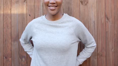 Midsection-of-happy-african-american-woman-in-grey-long-sleeve-sweatshirt,-copy-space,-slow-motion