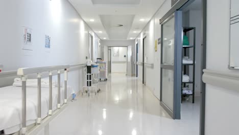 General-view-of-corridor-with-stretchers-and-wheelchair-at-hospital,-slow-motion