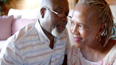 Senior-african-american-couple-talking-sitting-on-floor-at-home,-slow-motion