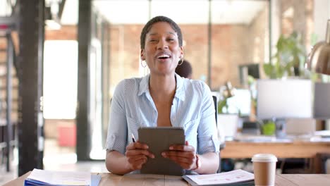 Portrait-of-happy-african-american-casual-businesswoman-having-video-call-and-talking,-slow-motion