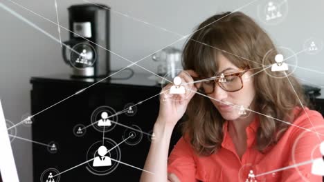 Animation-of-network-of-profile-icons-over-stressed-caucasian-woman-removing-glasses-at-office