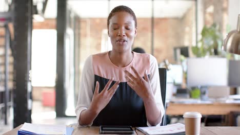 Portrait-of-happy-african-american-casual-businesswoman-having-video-call-and-gesturing,-slow-motion