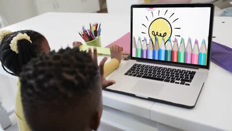 Happy-diverse-siblings-using-laptop-with-pencils-and-lightbulb-on-screen-in-slow-motion