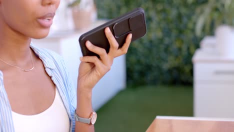 African-american-casual-businesswoman-talking-on-smartphone-in-office,-slow-motion