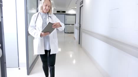 Caucasian-female-doctor-with-prosthetic-leg-in-hospital-corridor,-slow-motion,-copy-space