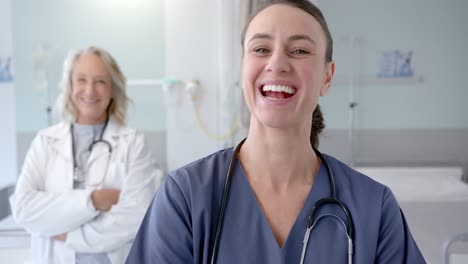 Portrait-of-happy-caucasian-female-doctors-in-hospital-room,-slow-motion