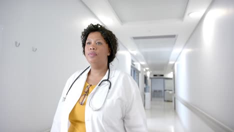 African-american-female-doctor-walking-in-hospital-corridor,-slow-motion