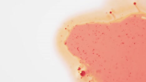 Video-of-close-up-of-red-and-yellow-ink-in-water-with-copy-space