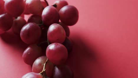 Video-of-red-grapes-with-copy-space-on-red-background