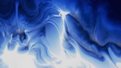 Video-of-close-up-of-blue-and-white-ink-in-water-with-copy-space