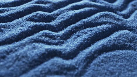 Video-of-close-up-of-blue-coloured-sand-with-pattern-and-copy-space-background