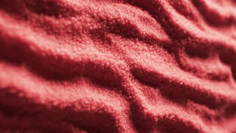 Video-of-close-up-of-red-coloured-sand-with-pattern-and-copy-space-background
