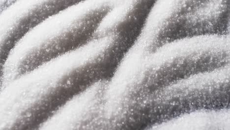 Video-of-close-up-of-white-sand-grains-with-pattern-and-copy-space-background