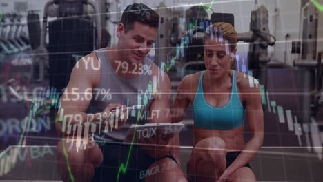 Animation-of-financial-data-procesisng-over-diverse-male-trainer-discussing-with-fit-woman-at-gym