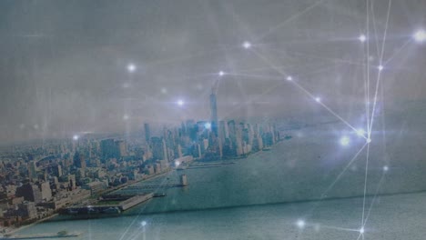 Animation-of-glowing-network-of-connections-against-aerial-view-of-cityscape