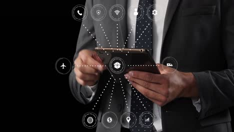 Animation-of-network-of-connections-with-icons-over-caucasian-businessman-with-tablet
