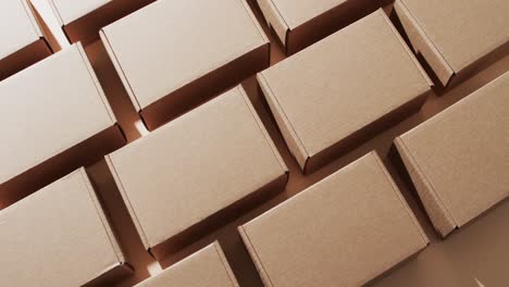 Video-of-cardboard-boxes-with-copy-space-over-brown-background