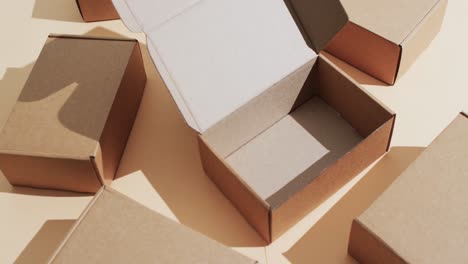 Video-of-cardboard-boxes-with-copy-space-over-brown-background