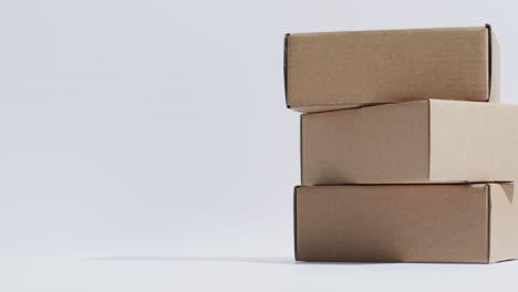 Video-of-stacked-cardboard-boxes-with-copy-space-over-white-background